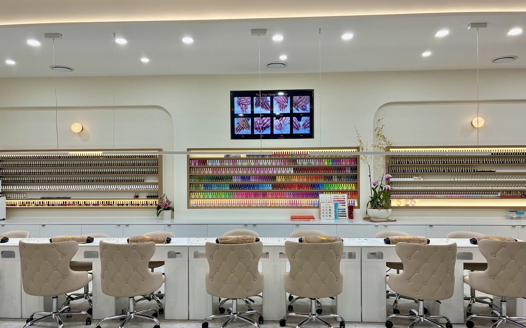 Inside Pro Nails & Beauty: a full wall of nail polish colours above the manicure stations