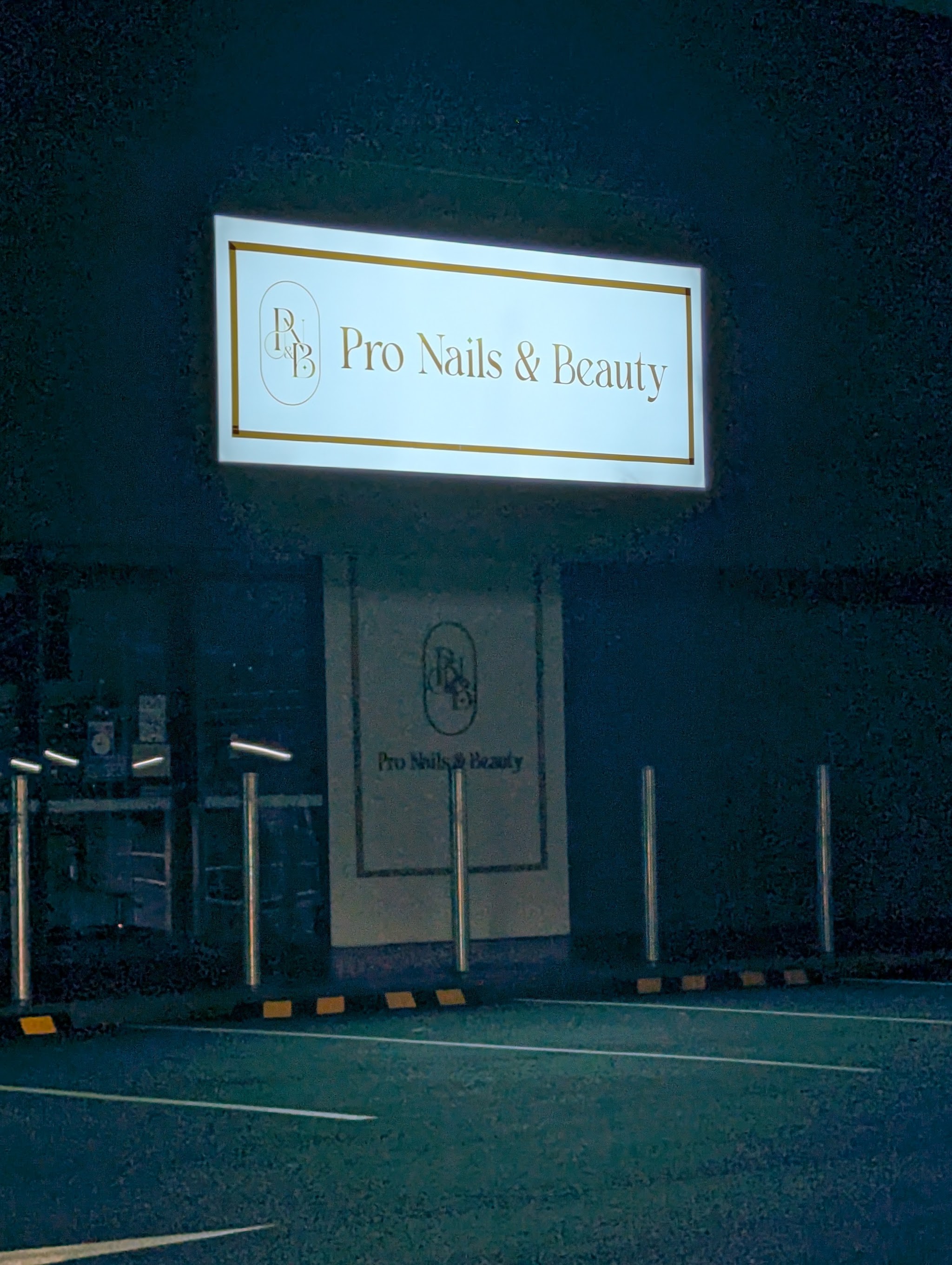 The illuminated Pro Nails & Beauty shopfront sign at night, Burpengary East Shopping Centre